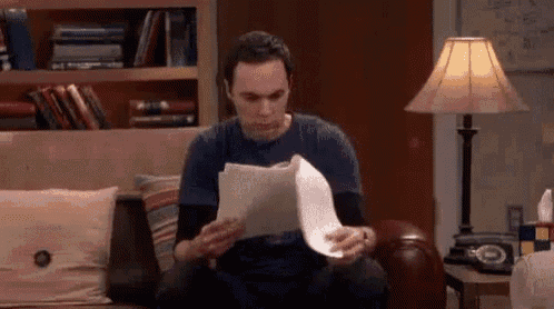 Sheldon cooper reading a paper and yelling WHY gif